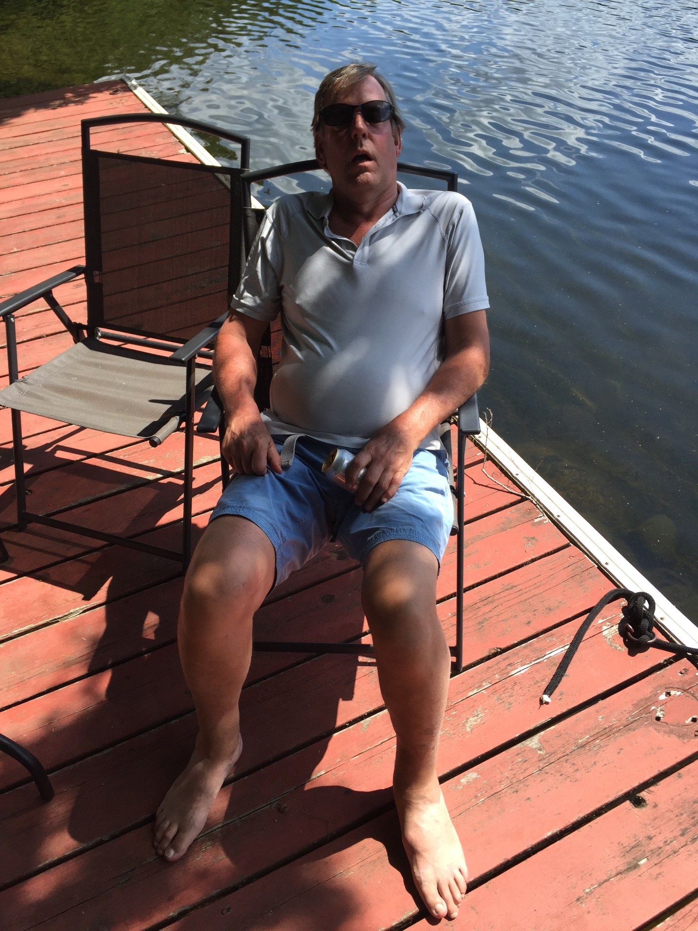 A friend relaxing in a chair on the dock by the lake