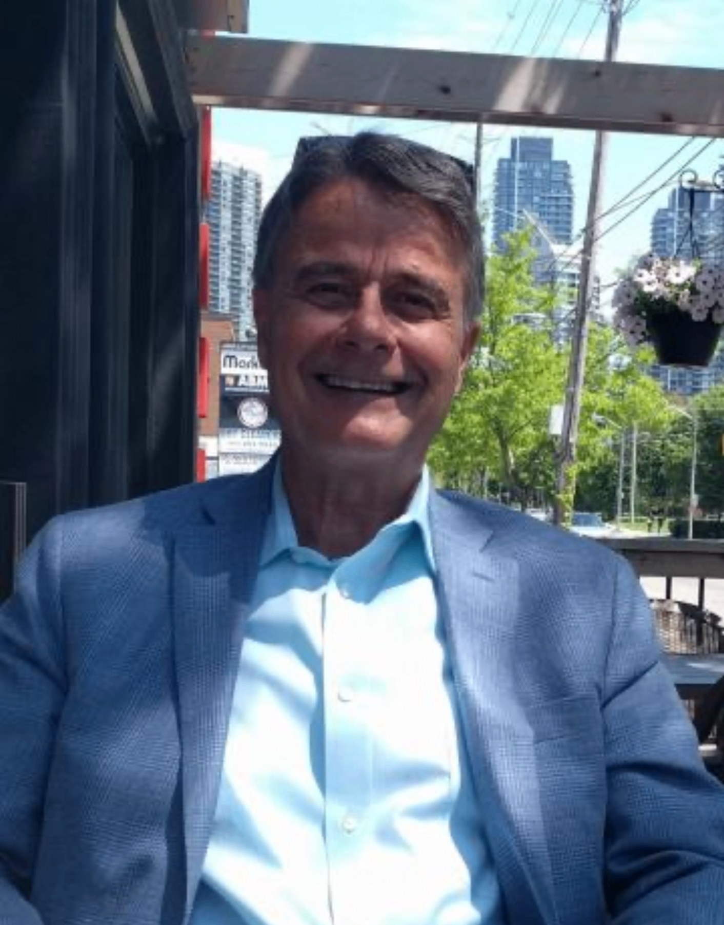 Hermie, Joe Colangelo's best friend, smiling on a sunny patio